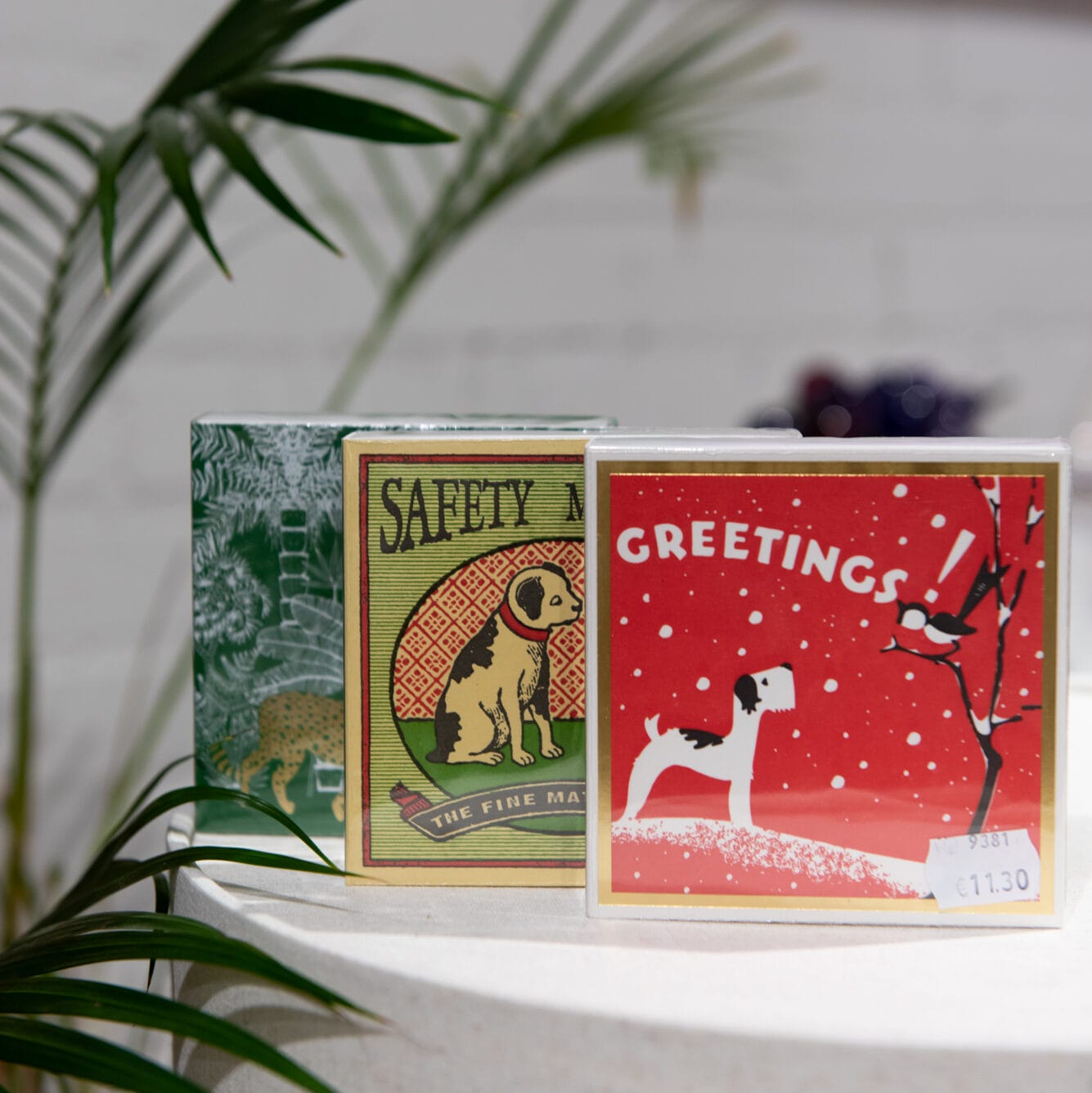 Kolme värikästä postikorttia pöydällä