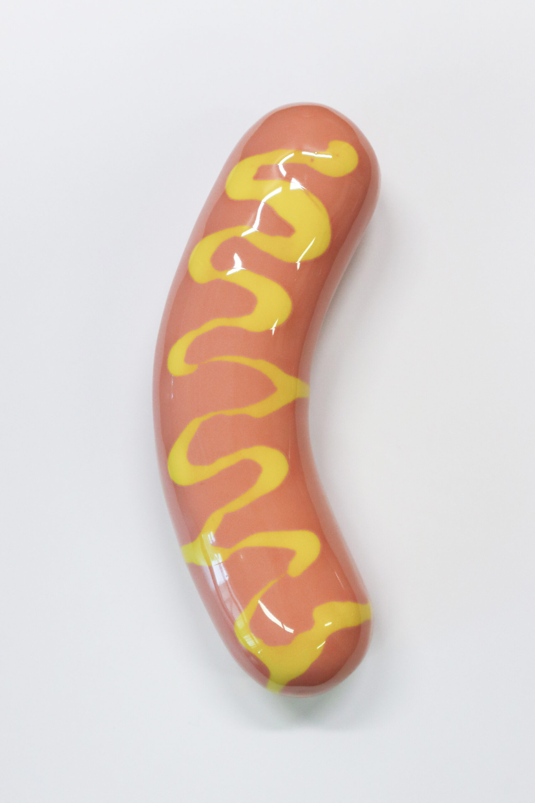 Hot dog -makkara sinapilla valkoisella taustalla