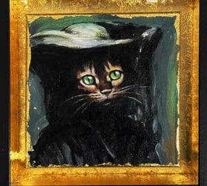 Musta kissa vihreät silmät kultakehyksessä