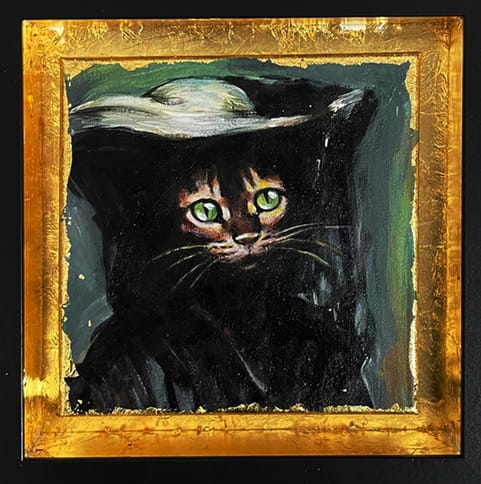 Musta kissa vihreät silmät kultakehyksessä
