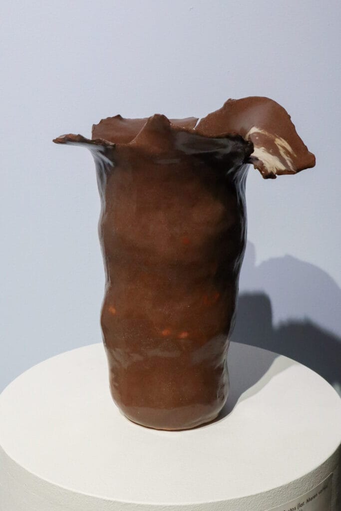 Ruskea keraaminen veistos jalustalla