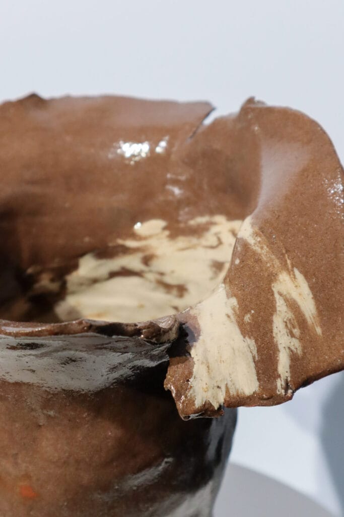 Ruskea keramiikkakulho epäsäännöllisellä reunalla