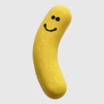 Keltainen banaani, jossa hymyilevä kasvot.