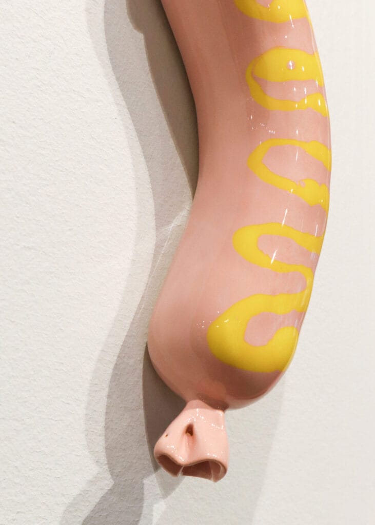 Koristeellinen veistos, pinkkiä ja keltaista lasia.