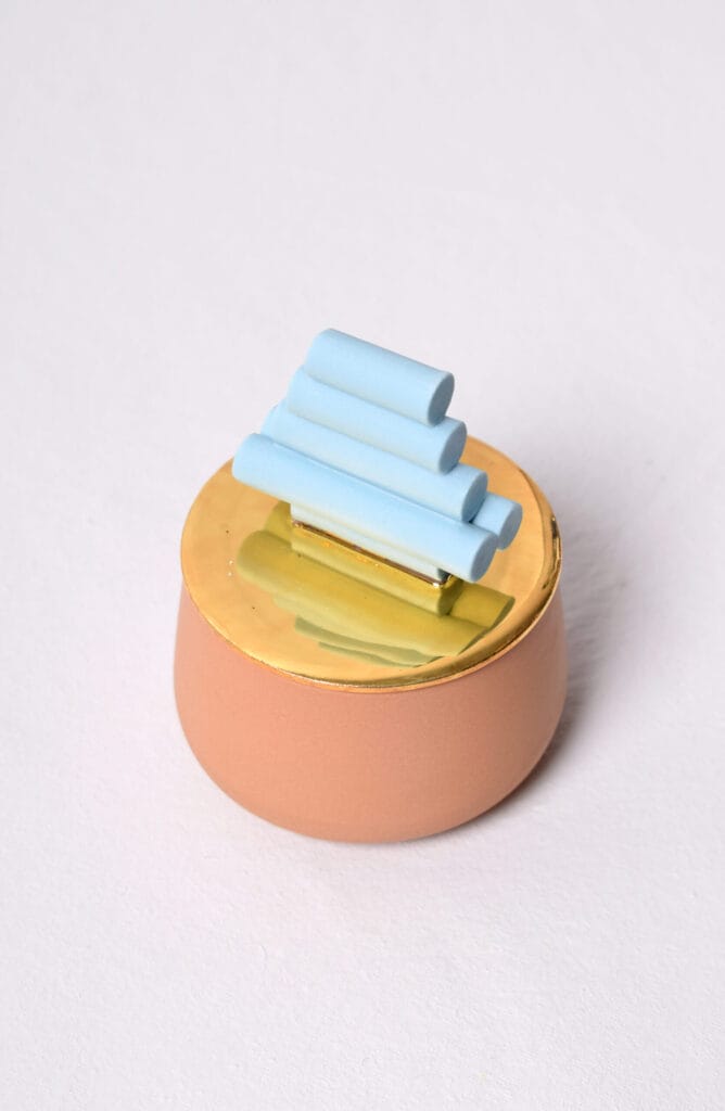 Koristeellinen sininen ja kultainen esine valkoisella taustalla.