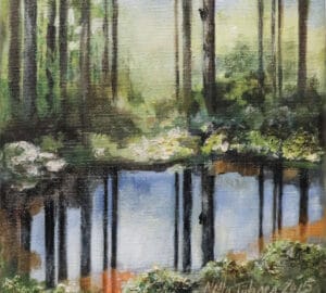 Metsämaisema heijastuksella vedessä