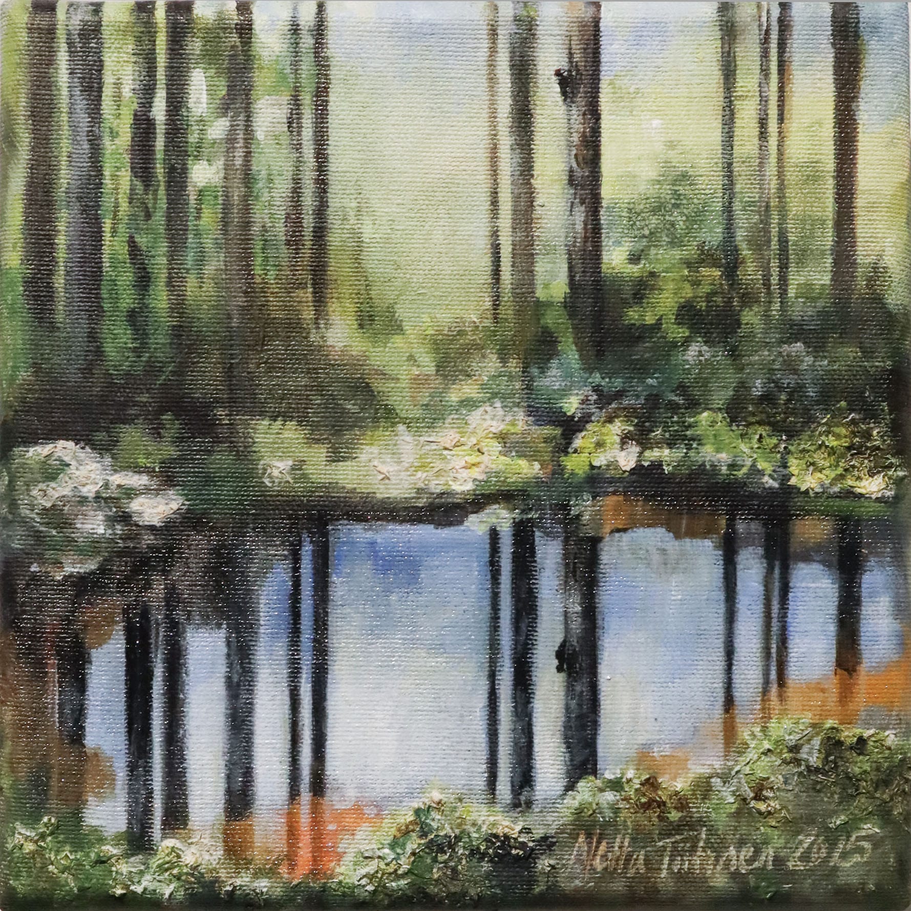 Metsämaisema heijastuksella vedessä