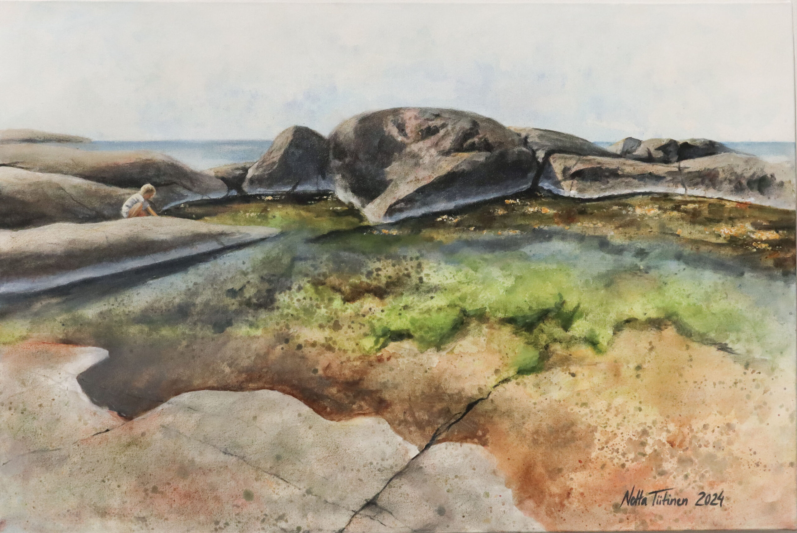 Maisemamaalaus rannalla, kiviä ja lapsi.
