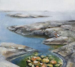 Lapsi kalliolla merenrannalla