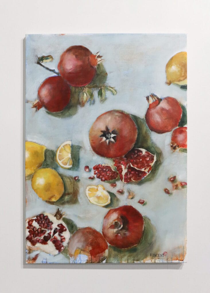 Still life of lemons and pomegranates.
